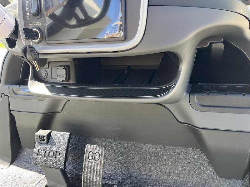 Dashboard showing digital display, steering wheel, and controls on the Club Car Onward 2 Passenger