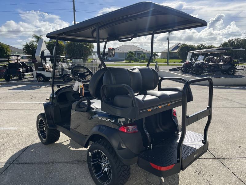 Side view of 2026 Club Car Onward Lifted 4 Passenger Gas golf cart with rugged tires