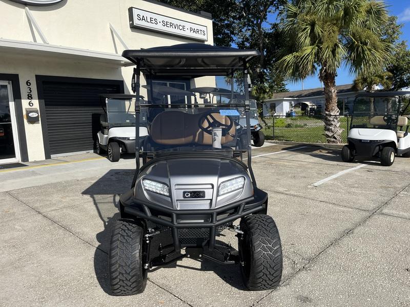 Side view of 2026 Club Car Onward Lifted 4 Passenger Gas grey golf cart in Texas
