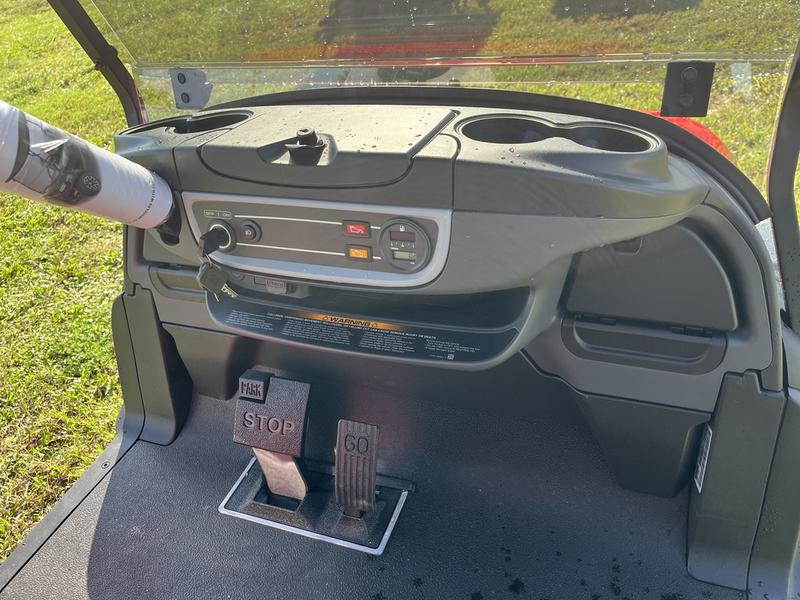 Dashboard and controls of 2026 Club Car Onward Lifted 4 Passenger Gas red California
