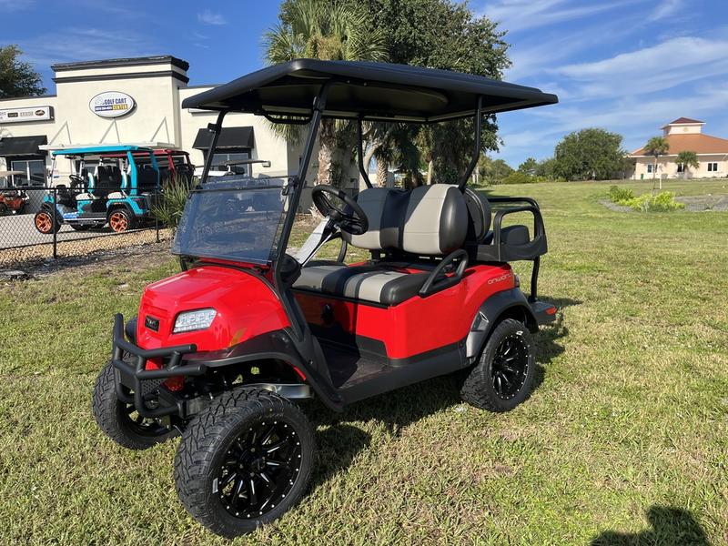 Side view of 2026 Club Car Onward Lifted 4 Passenger Gas red golf cart in California