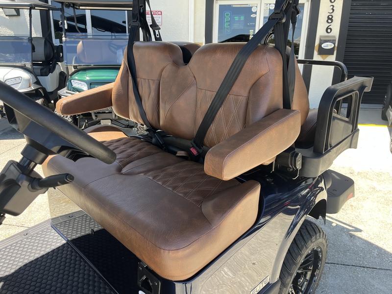 Side view of 2026 E-Z-GO Freedom RXV ELiTE Lithium Patriot Blue in Detroit Michigan