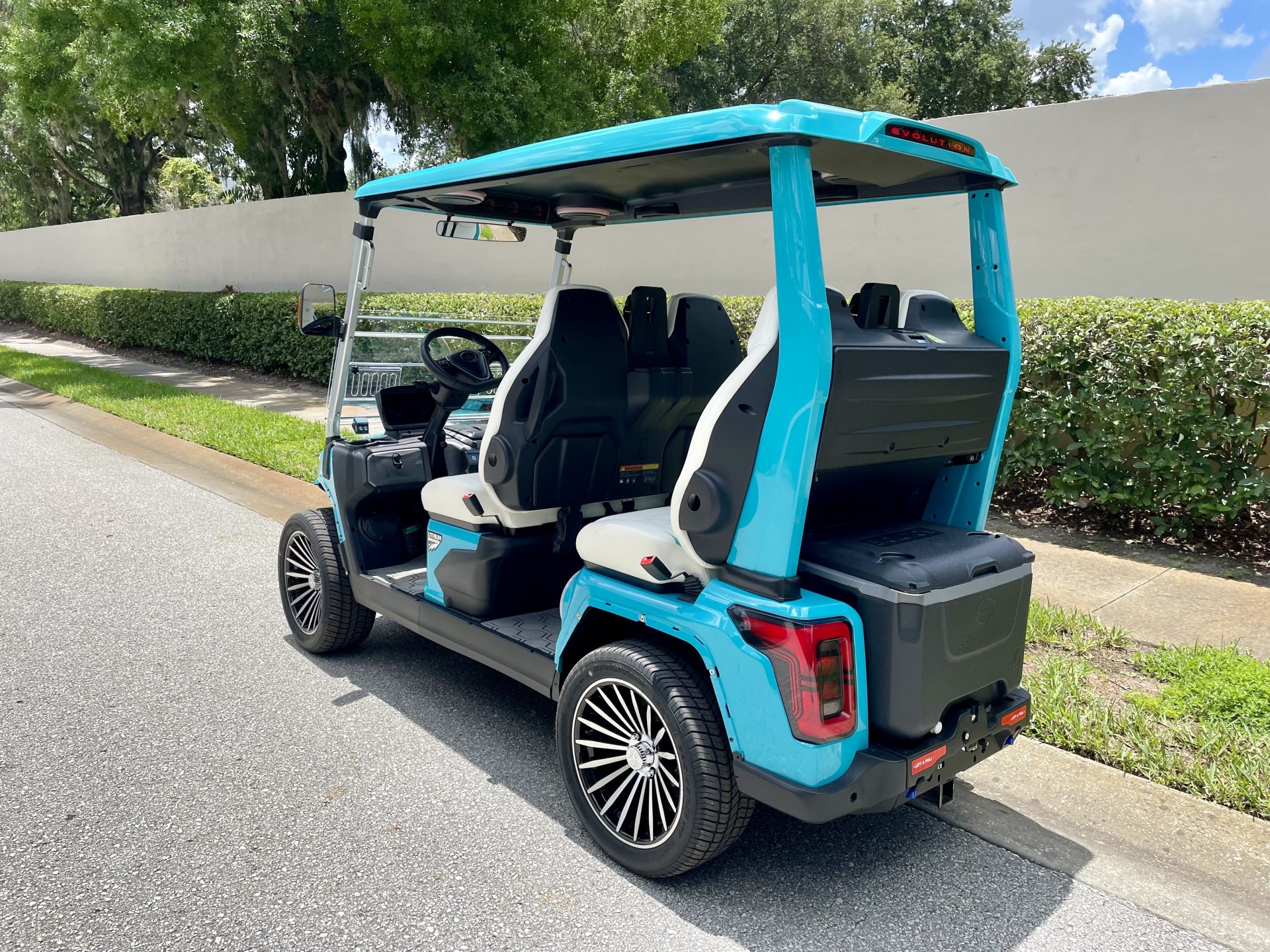 Side view of the 2026 Evolution D-Max GT4 Sky Blue with four forward-facing White seats